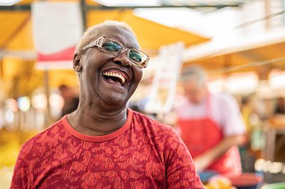 older woman in red laughing