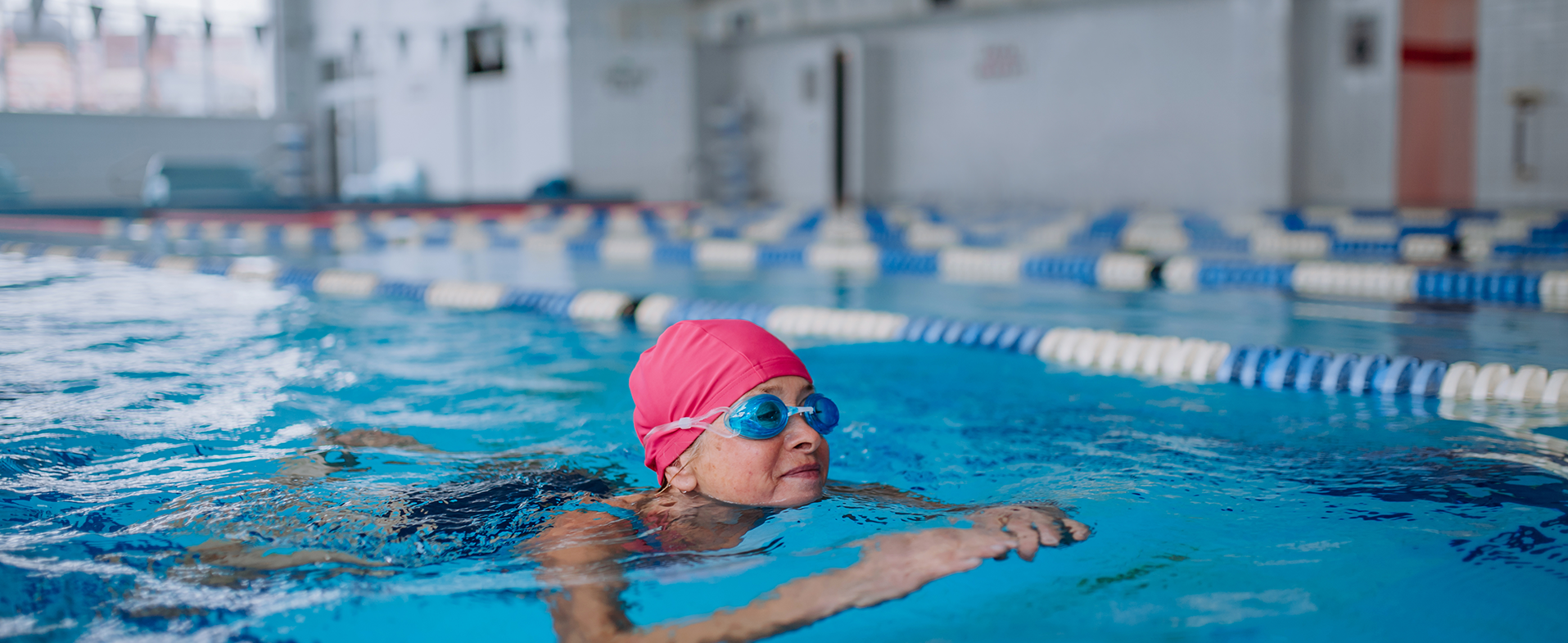 older woman swimming inside